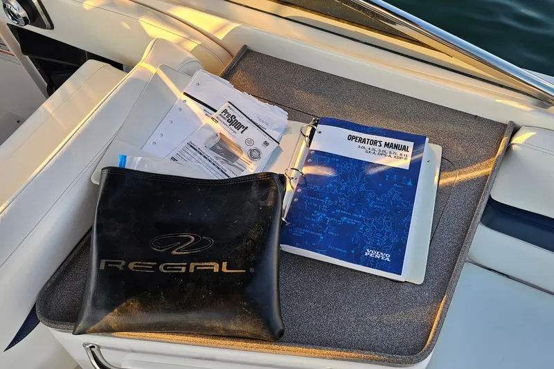 Slide: The Image of 2008 Regal 2700 ES Bowrider manuals and documents on boat seat. - 41