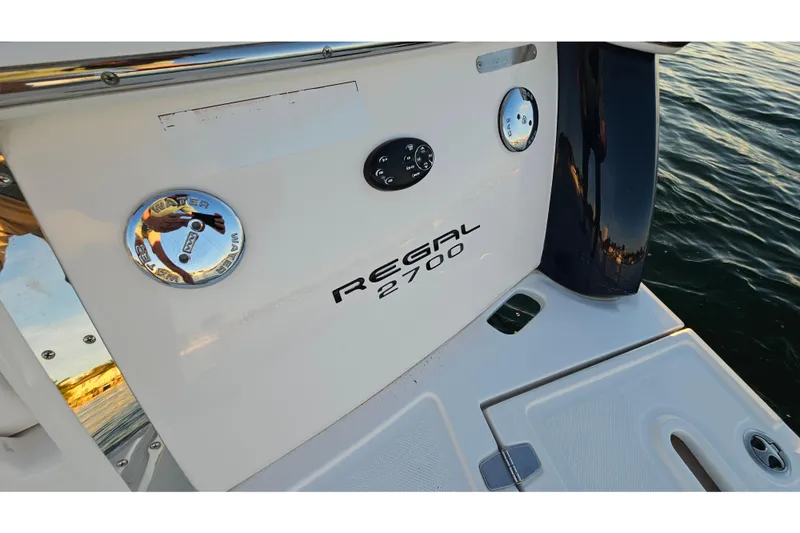 Slide: The Image of 2008 Regal 2700 ES Bowrider boat stern with water access and logo. - 49