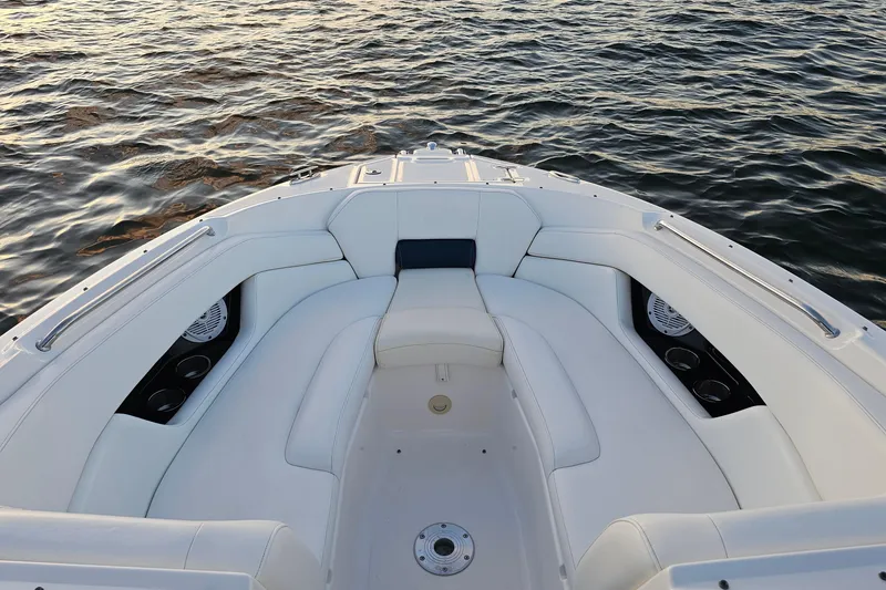 Slide: The Image of 2008 Regal 2700 ES Bowrider with white seating, on calm water. - 55