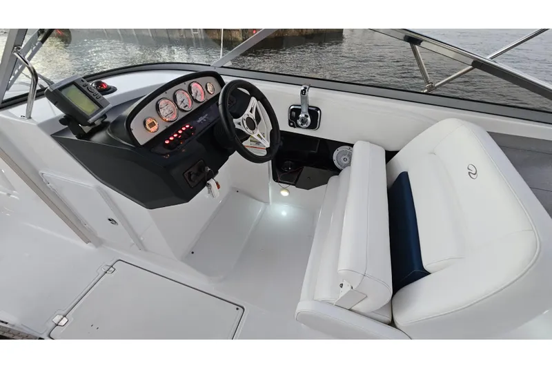 Slide: The Image of 2008 Regal 2700 ES Bowrider cockpit with steering wheel and white seating. - 58