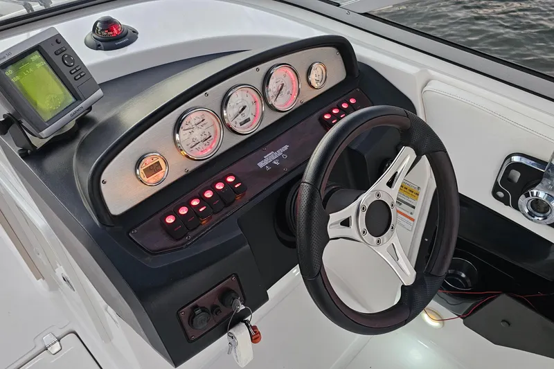 Slide: The Image of 2008 Regal 2700 ES Bowrider dashboard with steering wheel and gauges. - 59