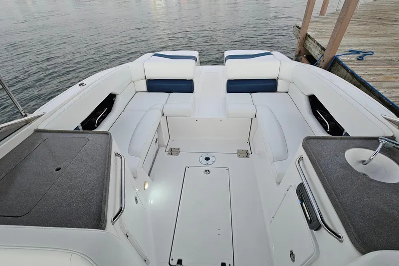 Slide: The Image of 2008 Regal 2700 ES Bowrider interior with white seating and a small sink. - 60