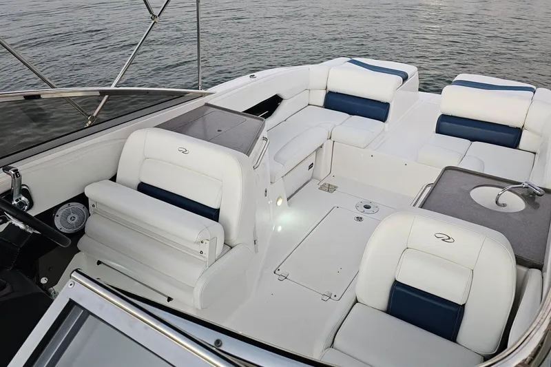 Slide: The Image of 2008 Regal 2700 ES Bowrider interior with white and blue seating, and a compact sink. - 64