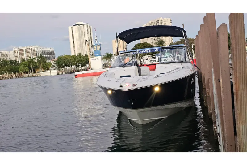 Slide: The Image of 2008 Regal 2700 ES Bowrider docked in a marina with cityscape background. - 66