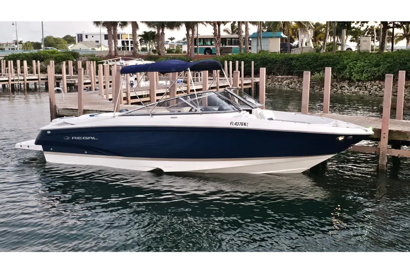 Slide: The Image of 2008 Regal 2700 ES Bowrider boat docked in marina, blue and white design. - 68