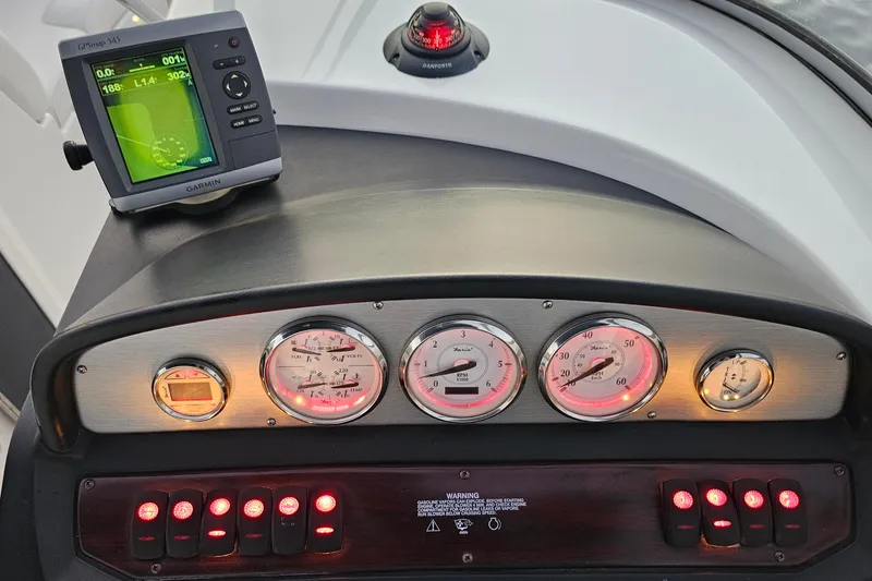 Slide: The Image of Dashboard of a 2008 Regal 2700 ES Bowrider with gauges and Garmin GPS. - 69