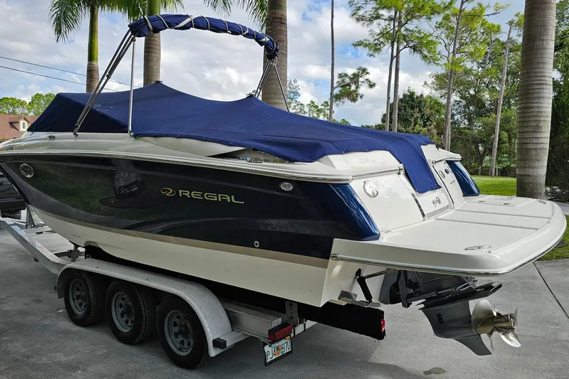 Slide: The Image of 2008 Regal 2700 ES Bowrider boat on trailer, covered, parked outdoors. - 79