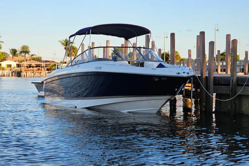 Slide: The Image of 2008 Regal 2700 ES Bowrider docked on calm water, sunny day. - 8