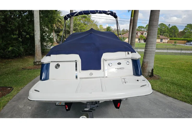 Slide: The Image of 2008 Regal 2700 ES Bowrider boat with blue cover, parked on driveway. - 80
