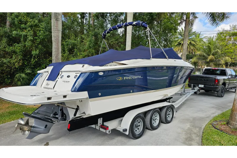 Slide: The Image of 2008 Regal 2700 ES Bowrider on trailer, parked near lush greenery. - 81