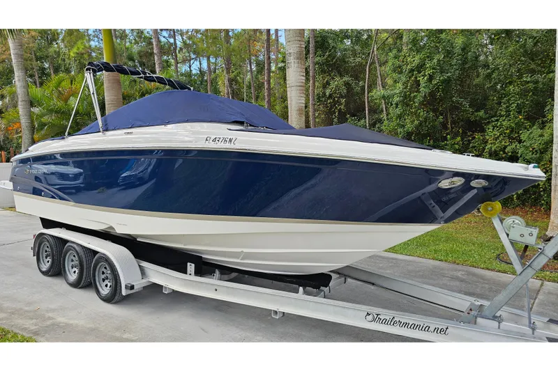 Slide: The Image of 2008 Regal 2700 ES Bowrider boat on trailer, covered, parked outdoors. - 83