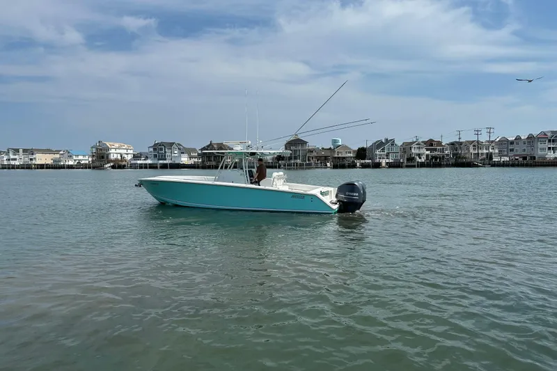 Slide: The Image of 2010 Jupiter 34 FS boat on calm water near coastal houses. - 10