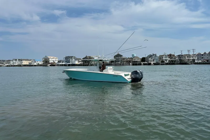 Slide: The Image of 2010 Jupiter 34 FS boat on calm water near coastal houses under blue sky. - 12
