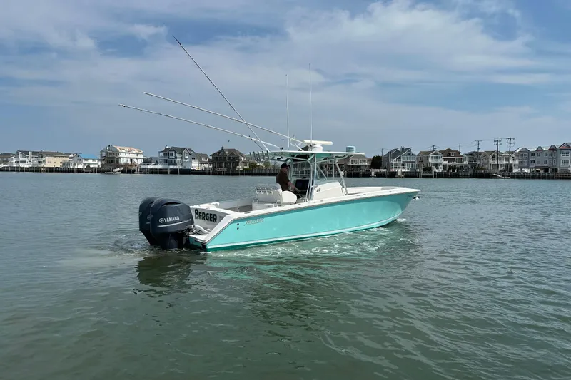 Slide: The Image of 2010 Jupiter 34 FS boat cruising on water near coastal homes. - 22