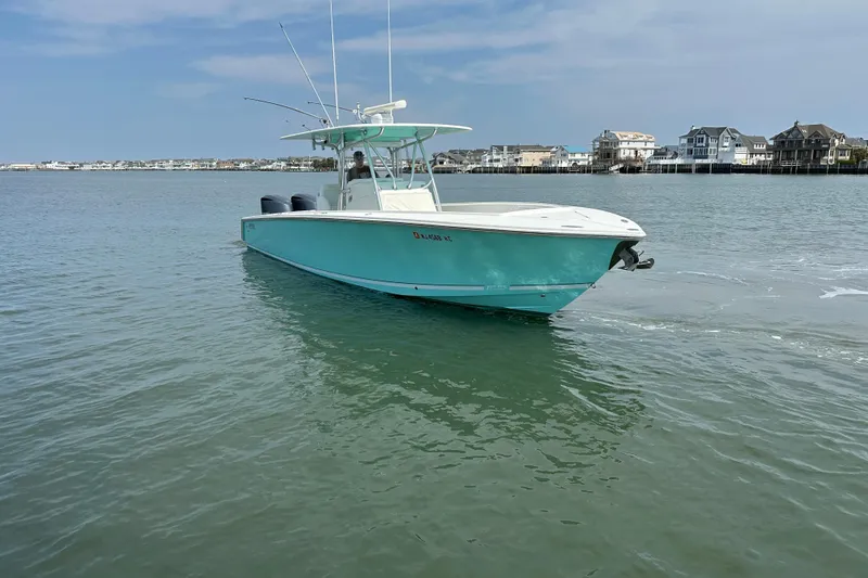 Slide: The Image of 2010 Jupiter 34 FS boat on calm water near coastal homes. - 23
