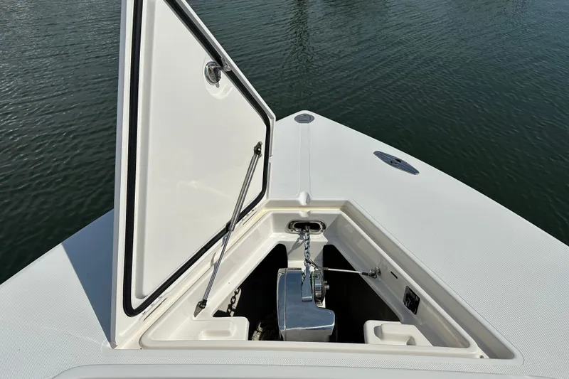 Slide: The Image of Open anchor compartment on 2010 Jupiter 34 FS boat, showing chain and mechanism. - 25