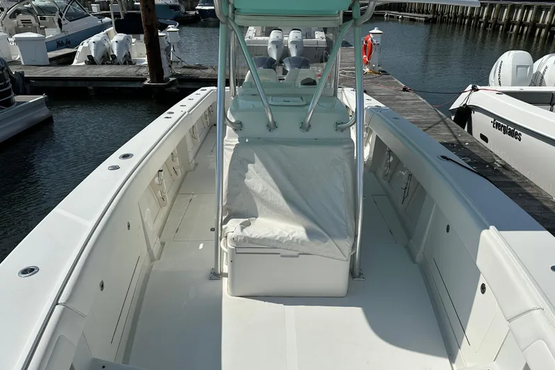Slide: The Image of 2010 Jupiter 34 FS boat docked, showcasing spacious deck and seating area. - 27
