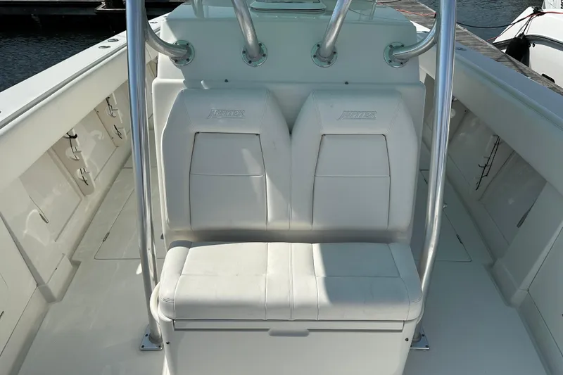 Slide: The Image of 2010 Jupiter 34 FS boat seating with white upholstery and stainless steel supports. - 28