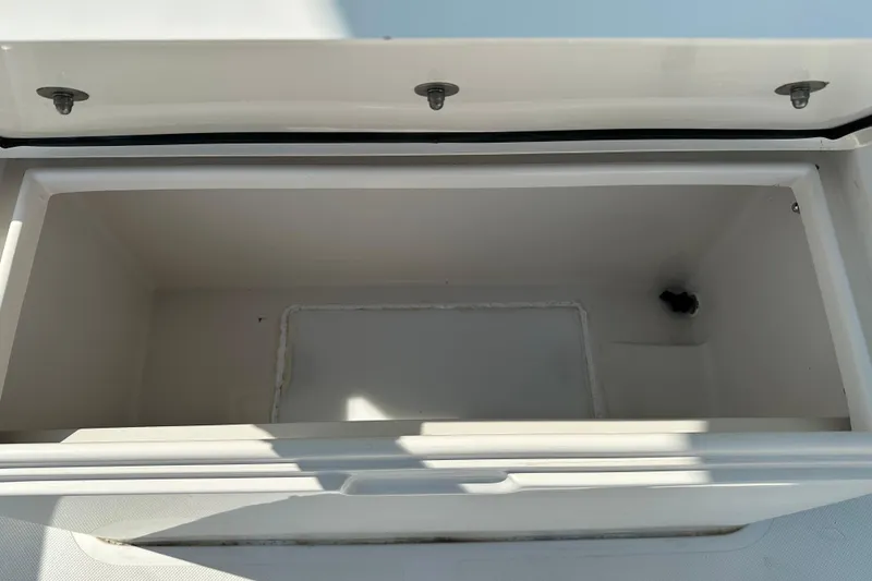 Slide: The Image of Open storage compartment on 2010 Jupiter 34 FS boat, showing interior space. - 29