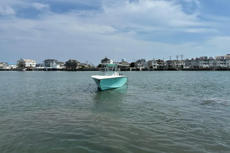 Slide: The Image of 2010 Jupiter 34 FS boat on calm water near coastal houses under blue sky. - 3