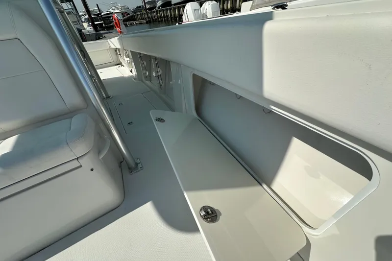 Slide: The Image of 2010 Jupiter 34 FS boat interior with open storage compartment and seating. - 33