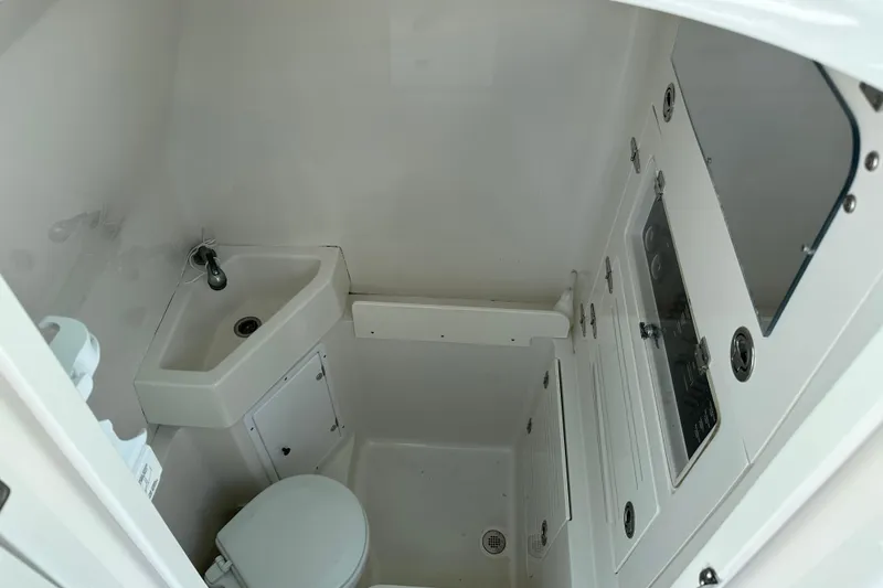 Slide: The Image of 2010 Jupiter 34 FS boat bathroom with sink, toilet, and storage compartments. - 35