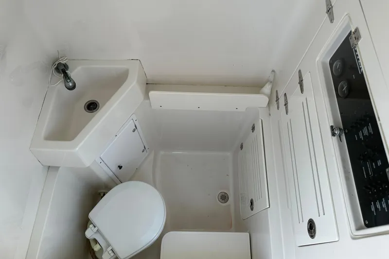 Slide: The Image of Compact bathroom in 2010 Jupiter 34 FS boat with sink, toilet, and storage compartments. - 36