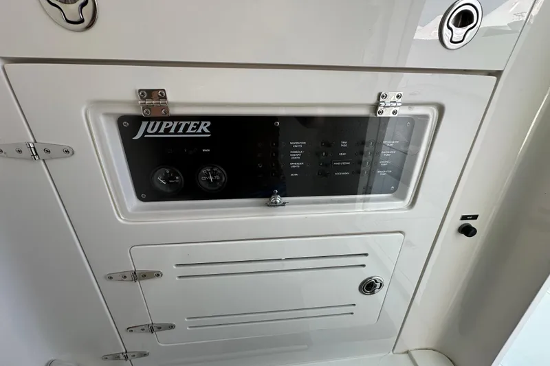 Slide: The Image of Control panel of a 2010 Jupiter 34 FS boat, featuring gauges and switches. - 37
