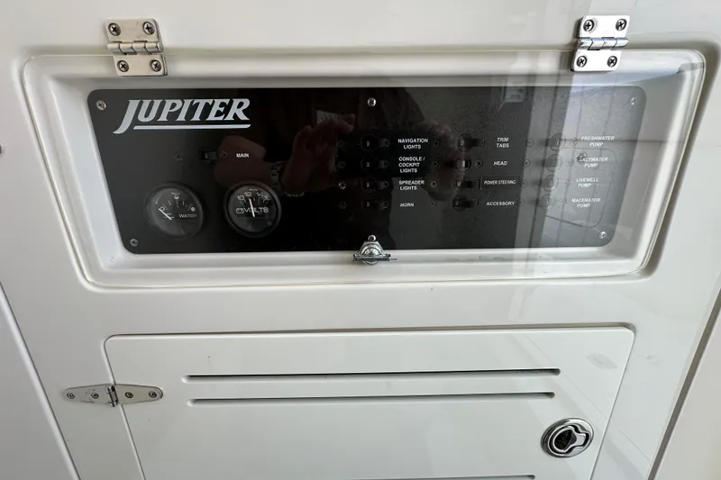 Slide: The Image of Control panel of a 2010 Jupiter 34 FS boat with gauges and switches. - 38