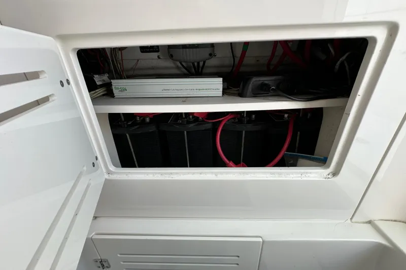 Slide: The Image of Electrical compartment of a 2010 Jupiter 34 FS boat, showing wiring and components. - 39