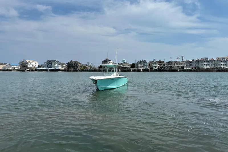 Slide: The Image of 2010 Jupiter 34 FS boat on calm water with coastal houses in the background. - 4