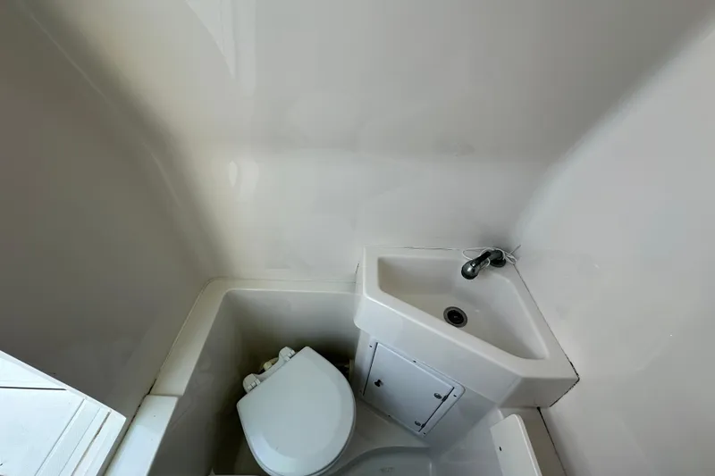 Slide: The Image of Compact bathroom in 2010 Jupiter 34 FS boat with sink and toilet. - 42