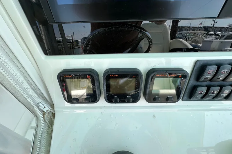 Slide: The Image of Dashboard of a 2010 Jupiter 34 FS boat with tachometer and speed fuel gauges. - 44