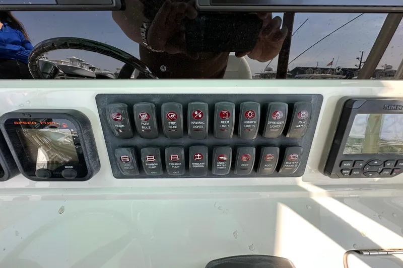 Slide: The Image of Control panel of a 2010 Jupiter 34 FS boat with various switches and displays. - 45