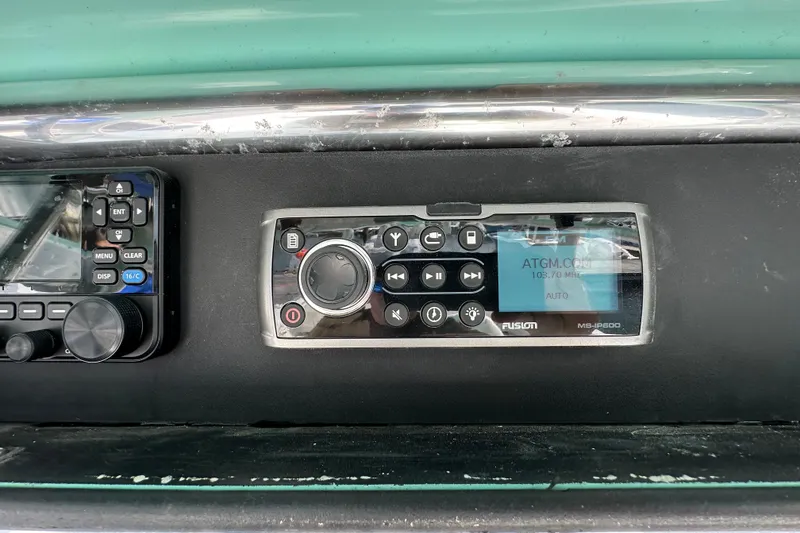 Slide: The Image of Fusion MS-IP600 marine stereo on 2010 Jupiter 34 FS dashboard. - 48