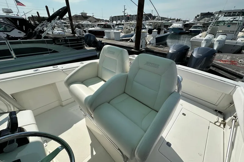 Slide: The Image of 2010 Jupiter 34 FS boat interior with white seating at a marina. - 50