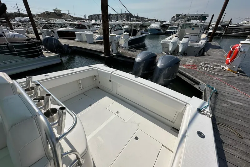 Slide: The Image of 2010 Jupiter 34 FS boat docked at marina with twin outboard engines. - 51