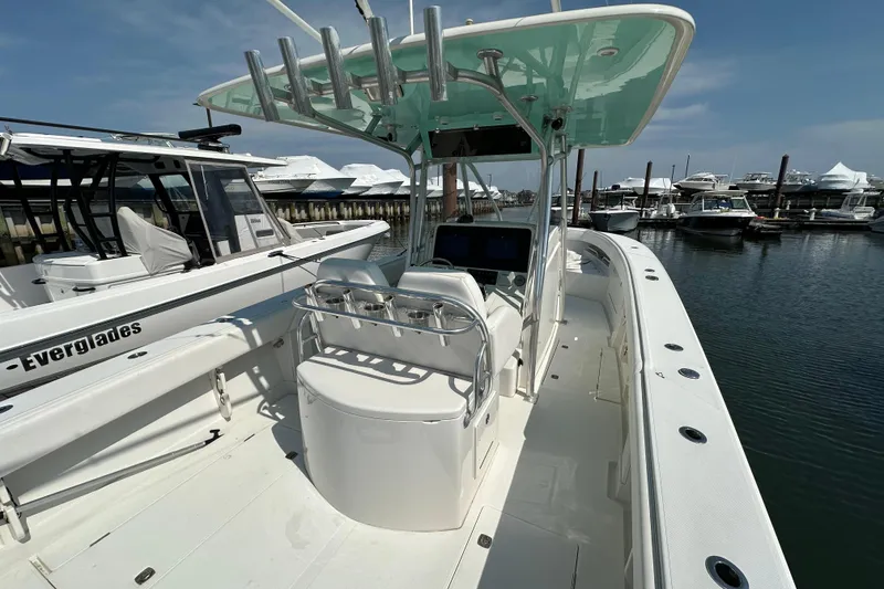 Slide: The Image of 2010 Jupiter 34 FS boat docked at marina, featuring sleek design and spacious deck. - 52