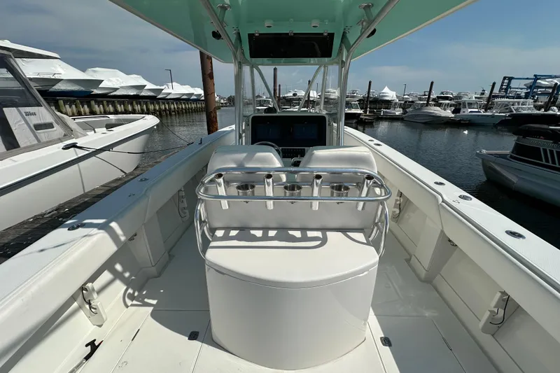 Slide: The Image of 2010 Jupiter 34 FS boat interior at marina, showcasing helm and seating area. - 53