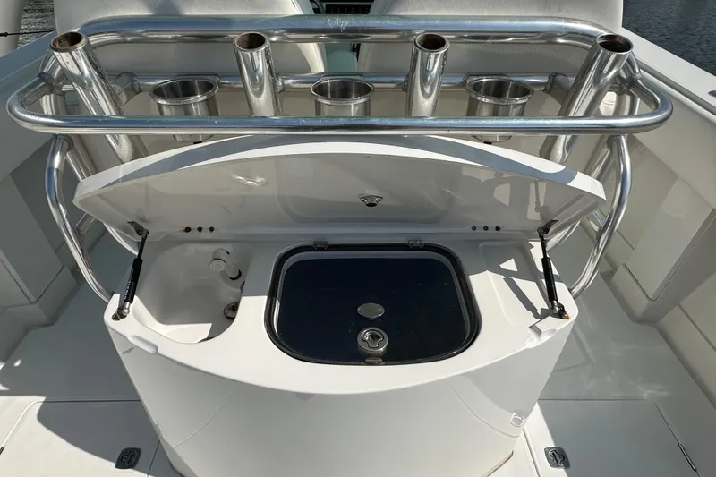 Slide: The Image of 2010 Jupiter 34 FS boat with open storage compartment and rod holders. - 55