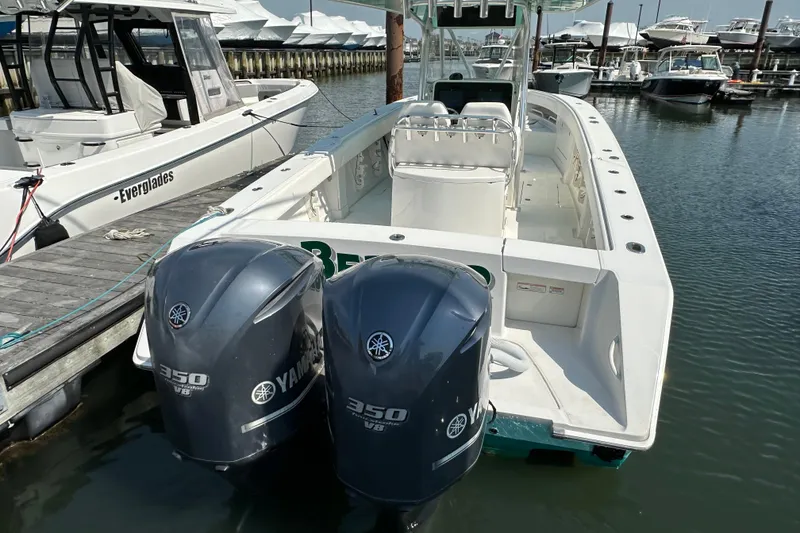 Slide: The Image of 2010 Jupiter 34 FS boat with twin Yamaha 350 engines docked at marina. - 58