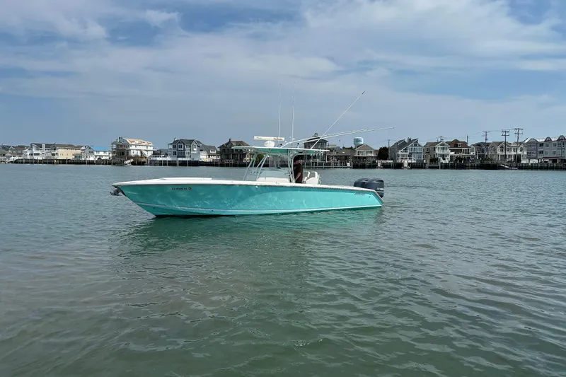 Slide: The Image of 2010 Jupiter 34 FS boat on calm water with coastal houses in the background. - 7