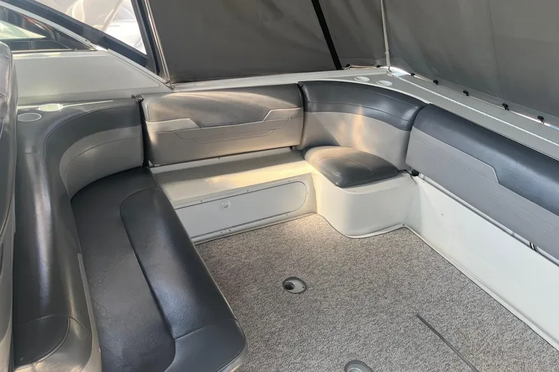 Slide: The Image of 2002 Formula 41 Performance Cruiser interior with gray seating and carpeted flooring. - 4