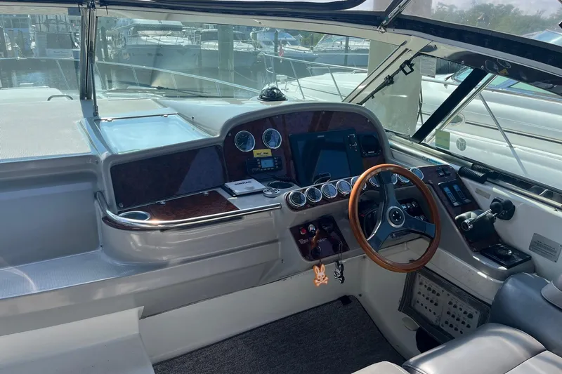 Slide: The Image of 2002 Formula 41 Performance Cruiser helm with wood accents and modern controls. - 5