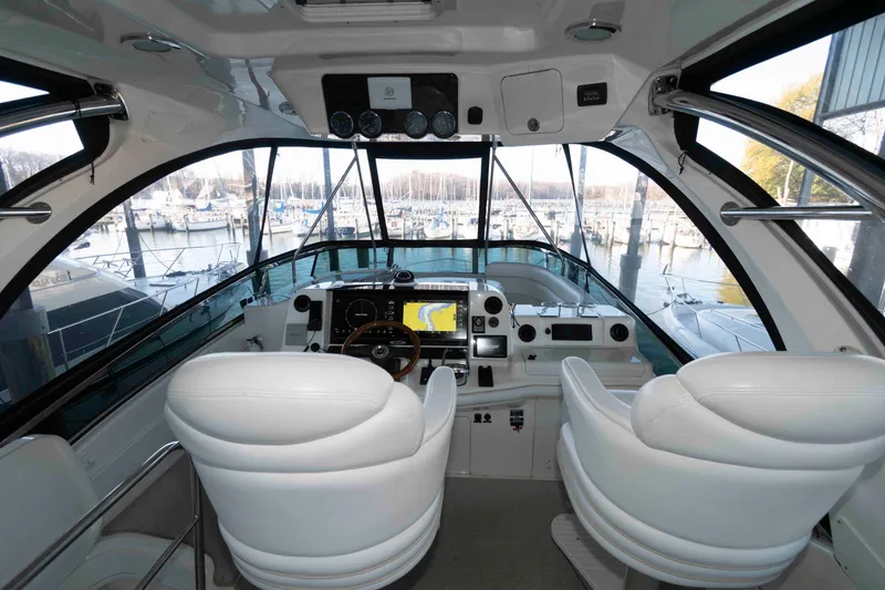 Slide: The Image of Interior view of 2008 Sea Ray 52 Sedan Bridge yacht cockpit with marina backdrop. - 15