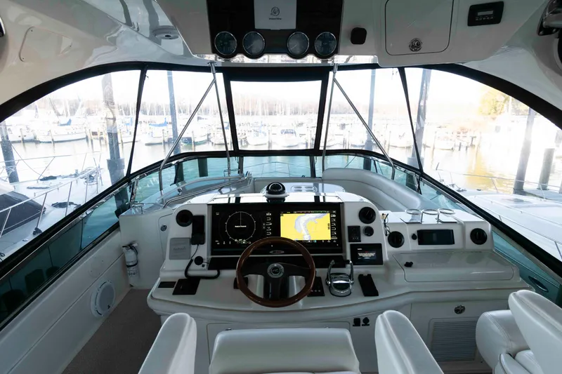 Slide: The Image of 2008 Sea Ray 52 Sedan Bridge helm with advanced navigation systems and marina view. - 16