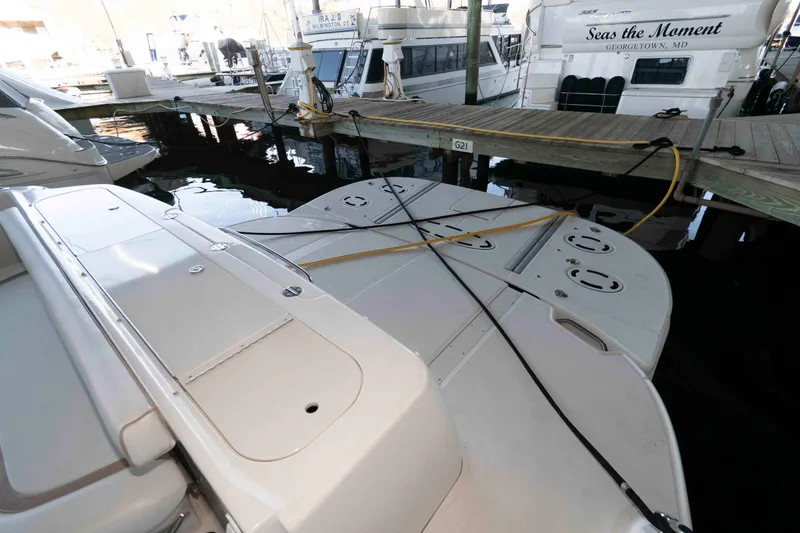 Slide: The Image of 2008 Sea Ray 52 Sedan Bridge yacht docked at marina with visible swim platform. - 17