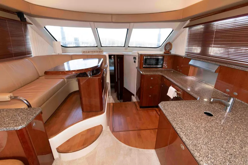 Slide: The Image of Luxurious interior of 2008 Sea Ray 52 Sedan Bridge yacht with modern kitchen and seating area. - 24