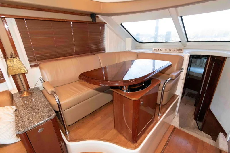 Slide: The Image of Luxurious interior of 2008 Sea Ray 52 Sedan Bridge with elegant seating and dining area. - 25