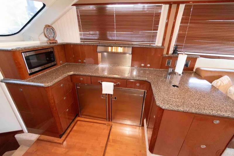 Slide: The Image of Luxurious kitchen interior of 2008 Sea Ray 52 Sedan Bridge yacht with granite countertops. - 26
